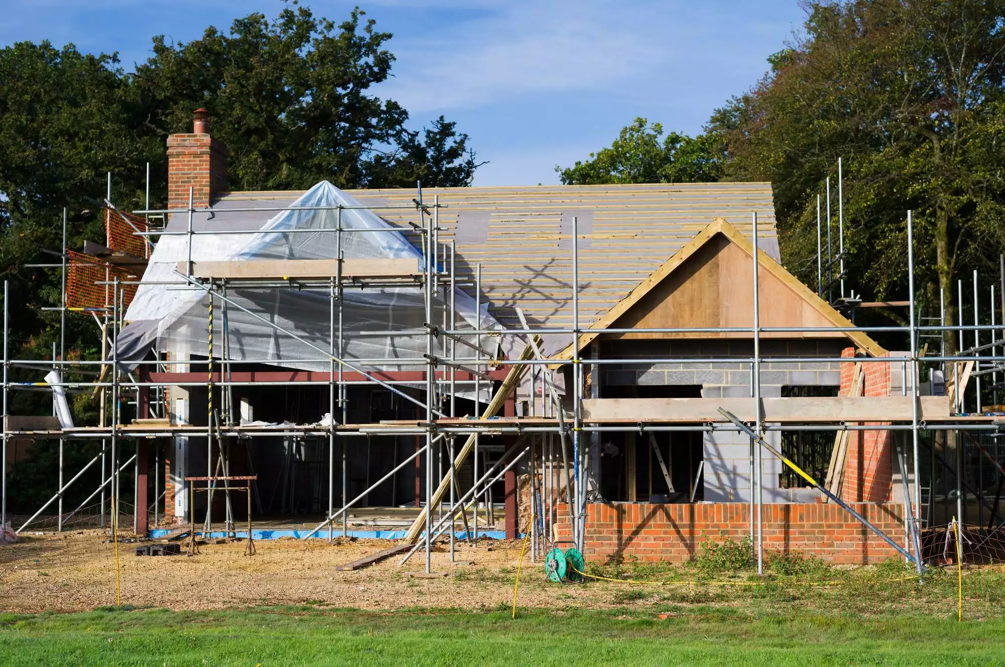 A family home under construction. A building site with scaffolding.